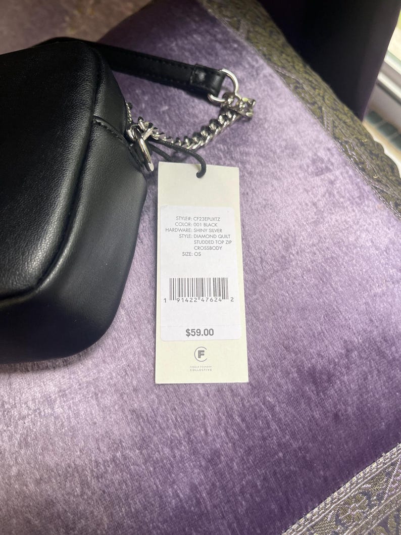 May include: Black crossbody bag with a diamond quilt pattern and studded top zip. The bag has a silver chain strap and a tag with the text "CF23EPUKTZ", "001 BLACK", and "SHINY SILVER".