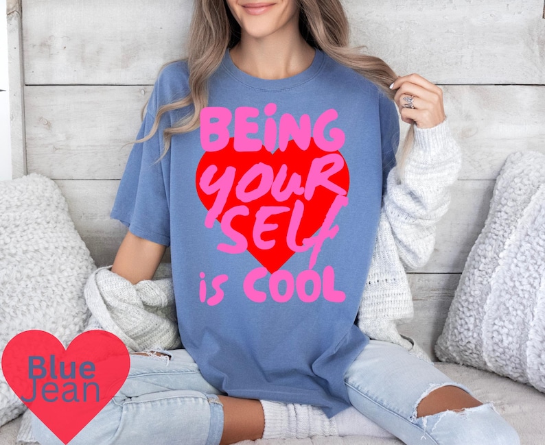May include: A blue t-shirt with a pink and red heart graphic that says "Being Your Self is Cool".