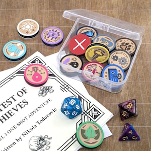 May include: A collection of game tokens with various symbols, a clear plastic container, dice, and a booklet titled "CONTEST OF THIEVES". The tokens are round with colorful designs. The dice are blue and purple. The booklet is white with black text.