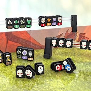 Op de afbeelding: Een bordspelaccessoireset met zwarte plastic clips voorzien van diverse iconen zoals schedels, zandlopers en pootafdrukken. De set bevat twee horizontale stangen op zwarte standaards en diverse losse clips die op een groen raster zijn geplaatst.