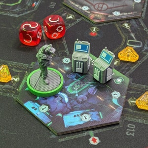 May include: A green and gray game board with a gray figure, two gray computer terminals, and four yellow triangular tokens. There are also two red dice with white numbers.