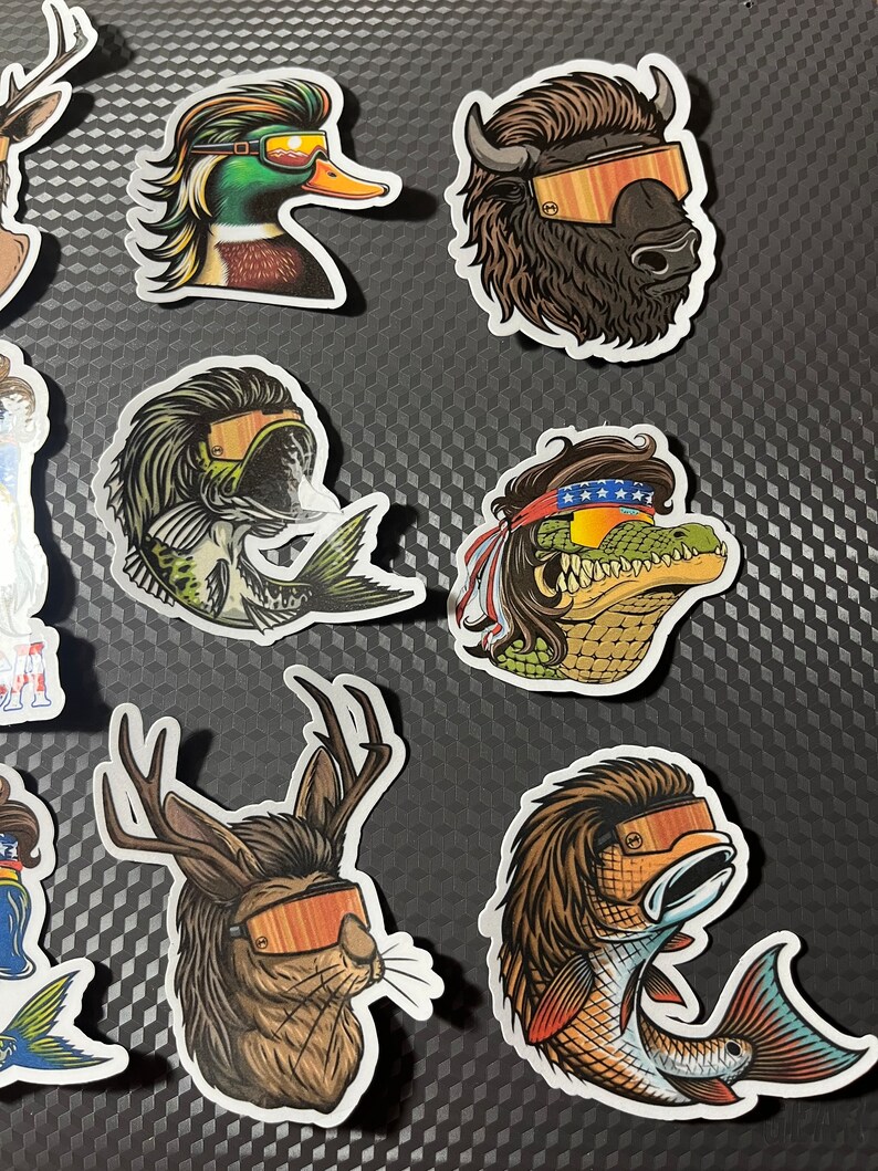 May include: A set of nine colorful stickers featuring various animals wearing sunglasses. The animals include a duck, a fish, a deer, a buffalo, a crocodile, and a fish. The stickers are all in a cartoon style and have a fun and whimsical feel.