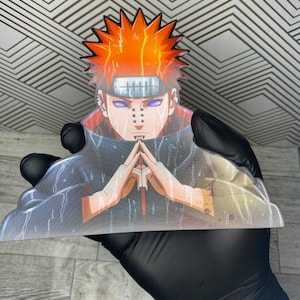 May include: A red-haired anime character with a headband and a dark blue and gray outfit. The character has purple eyes and a serious expression. The character is holding their hands together in a prayer position.