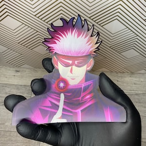 May include: A sticker featuring a character with white hair, a purple and black outfit, and a red eye. The character is pointing with their index finger.