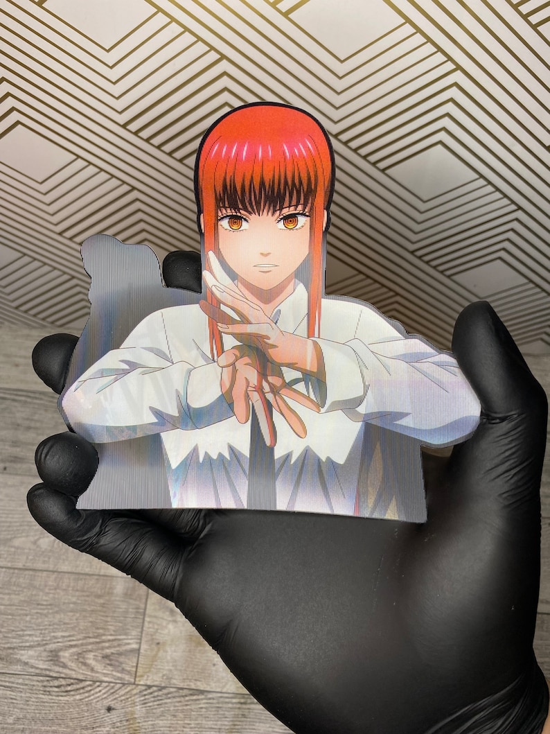 May include: A white button-down shirt with a black tie. The shirt has a holographic effect and the character from the anime "Food Wars!" is wearing it. The character has red hair and brown eyes.