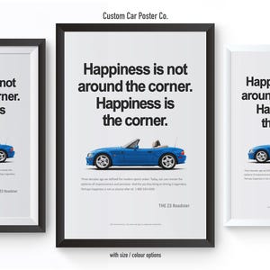 May include: Three framed posters with a blue convertible car illustration. Each poster has the text "Happiness is not around the corner. Happiness is the corner." The posters are in black and white frames.