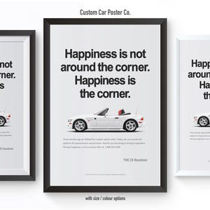 May include: Three framed posters with a white convertible car illustration. Each poster features the text "Happiness is not around the corner. Happiness is the corner." The posters are in black and white frames.