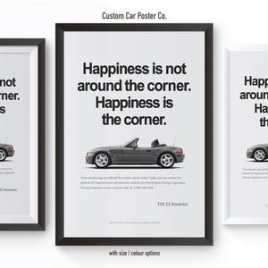 May include: Three framed posters with a minimalist design. Each poster features a gray convertible car and the text "Happiness is not around the corner. Happiness is the corner." The posters are in black and white frames.