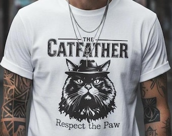 May include: White t-shirt featuring a black and white graphic of a cat wearing a fedora, with the text "THE CATFATHER" above and "Respect the Paw" below. The shirt has rolled-up sleeves.