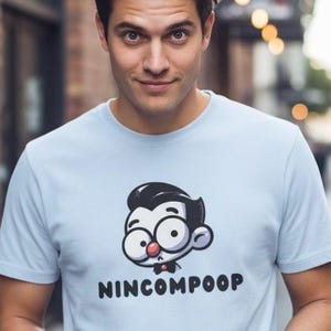 Koszulka z grafiką Nincompoop: Zabawna, unisexowa bawełniana koszulka