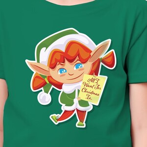 Camiseta infantil de Natal com elfo alegre - "Tudo o que eu quero no Natal é..." Elfo segurando uma carta para o Papai Noel - Camiseta infantil de Natal - Para crianças pequenas e jovens