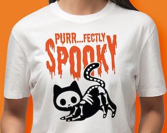 May include: White t-shirt with a black and white skeleton cat graphic and the text "PURR...FECTLY SPOOKY" in orange.