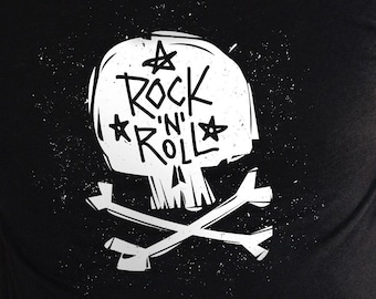 May include: Black t-shirt featuring a white skull graphic and the text "Rock 'n' Roll" in a grunge style font.