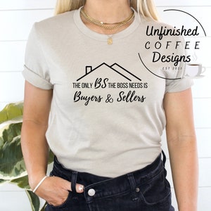 May include: A light gray t-shirt with a black house graphic and the text "The only BS the boss needs is Buyers & Sellers". The shirt is part of a collection called "Unfinished Coffee Designs" and has the text "EST 2023" on the bottom right corner.