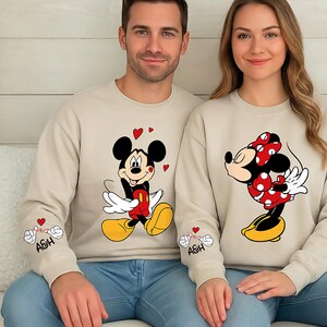 This matching couples top features a playful Mickey-style character and a sweet Minnie-inspired pose, making it the perfect gift for Valentine’s Day or any romantic occasion. Soft, comfortable, and available as a shirt, sweatshirt, or hoodie, it makes a fun outfit for photos, vacations, date nights, and cozy days at home. Personalize the sleeve initials to create a meaningful and unique piece for your partner.