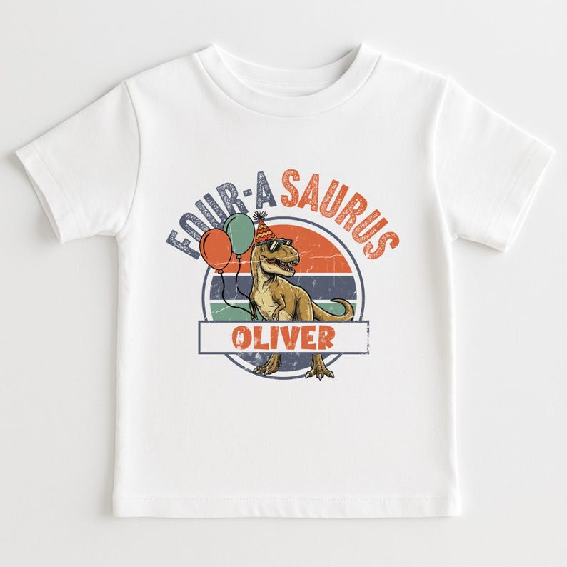 Front view of a "Four-a-Saurus" birthday sweatshirt for a four-year-old boy. The design uses earthy tones like mustard yellow, olive green, and rust orange against a neutral beige fabric. This preppy and modern garment is perfect for a rustic or boho-themed dinosaur birthday party and provides a trendy look for toddlers in 2026.