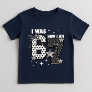 Mockup of the "I Was 6 Now I Am 7" design on a cozy sweatshirt. This option is perfect for fall or winter birthdays. The playful graphic with stars and animal prints stands out beautifully against the fabric. It is a comfortable and warm choice for a birthday girl who wants to look stylish while staying cozy during her special day or birthday trip.