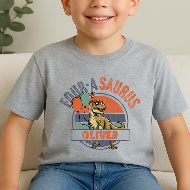 Visual description of the dinosaur party theme on a toddler hoodie. The T-Rex is wearing a festive red and yellow party hat and sunglasses, looking ready for a "Four-Rex" celebration. The background features a vintage striped sun in earth tones, creating a retro aesthetic popular for 2026 kids' fashion milestones and birthday outfits.