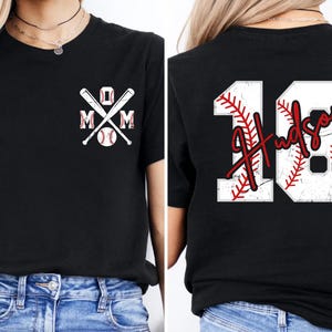 A shot highlighting the red script font. The name "Hudson" is written in a fluid, handwriting style that overlays the rigid block numbers, creating a modern and stylish aesthetic for sports parents.