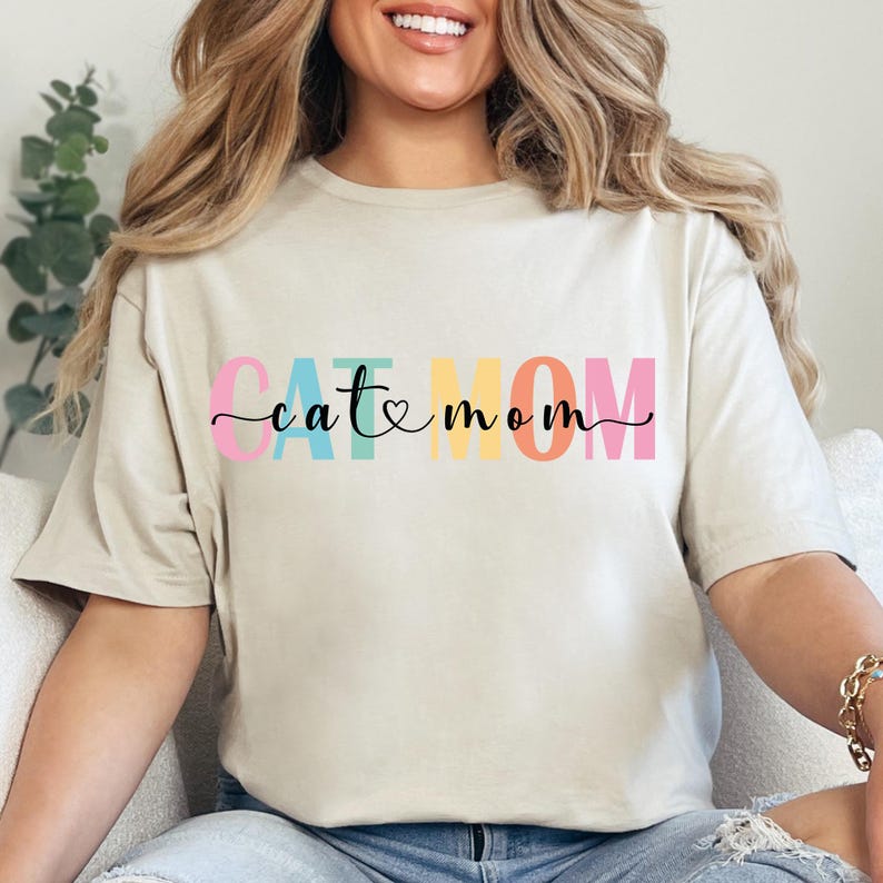 a woman sitting on a couch wearing a t - shirt that says eat mom