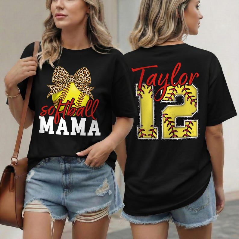 A black t-shirt modeled on a woman featuring a vibrant "Softball MAMA" design. The graphic centers on a large neon yellow softball adorned with a cheetah print ribbon bow. The text "softball" is in red script, and "MAMA" is in bold white block letters.