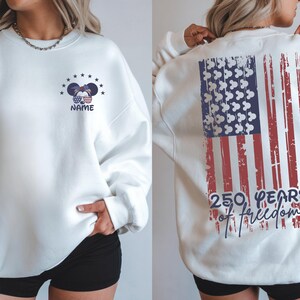 Detailed close-up of the back typography. The text "250 YEARS" is written in a bold, blue sans-serif font, while "of freedom" is written in a fluid, navy blue script font. The text overlaps the distressed red stripes of the flag.