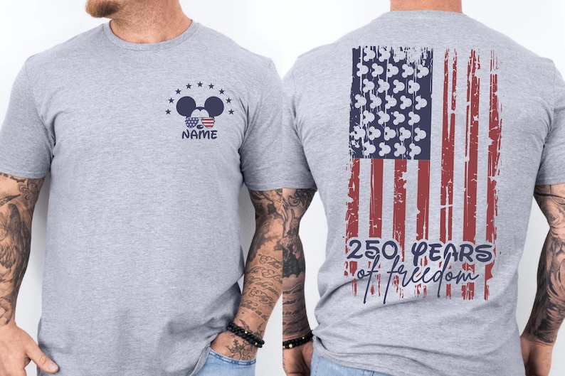A gray t-shirt with a graphic design on the back, depicting an American flag and the text "250 YEARS OF FREEDOM" printed on it.