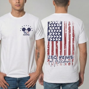 Rear view of the shirt showing the "250 Years of Freedom" design. A large vertical American flag dominates the back. The blue field of the flag is filled with white Mickey Mouse head silhouettes instead of traditional stars, creating a unique Disney twist.
