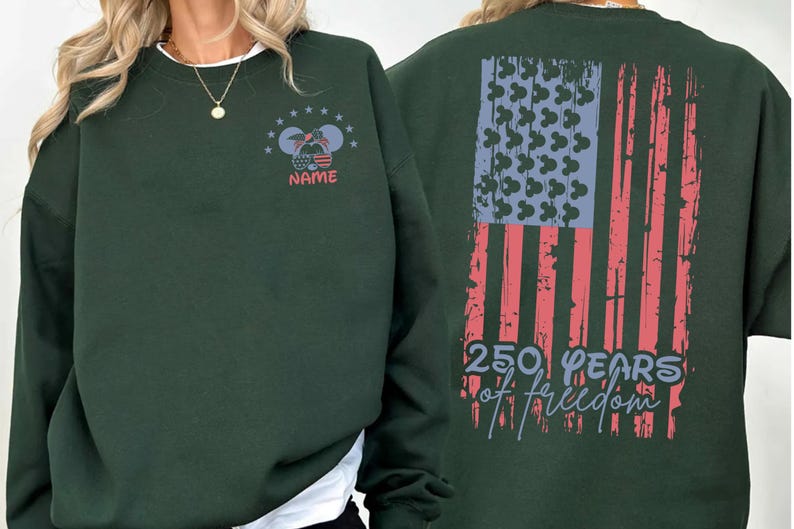A green sweatshirt with a graphic design on the back, featuring an American flag and the text "250 YEARS OF FREEDOM".
