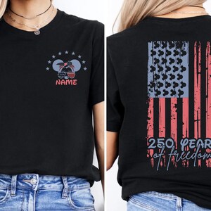 a black t-shirt with a graphic design on the back, featuring an American flag and the text "250 YEARS OF FREEDOM".