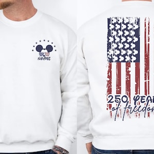 A white sweatshirt with an American flag design and the text "250 years of freedom" printed on the back.