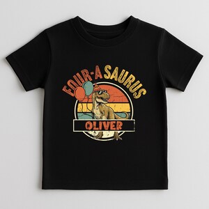 A toddler hoodie displayed in a bright studio setting. The "Four-a-Saurus" design is centered on the chest, focusing on the milestone of turning four years old. The earthy color palette and the personalized name feature make it a versatile and stylish piece for any toddler's wardrobe or a special birthday event.