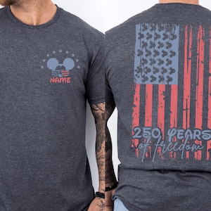 A gray t-shirt with a graphic design on the back, depicting an American flag and the text "250 PEARS OF FREEDOM" printed on it.