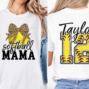 Detailed close-up of the back graphic. The yellow fill of the number "12" has red stitching details, mimicking the seams of a real softball. The script name "Taylor" contrasts boldly against the black background, ensuring high visibility.