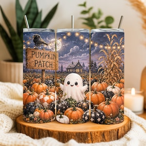 May include: A cylindrical tumbler with a metal straw featuring a Halloween scene with a ghost, orange and patterned pumpkins, a wooden sign reading PUMPKIN PATCH, a crow, a house, and string lights against a night sky with a full moon.