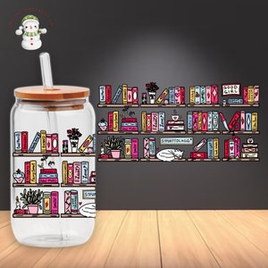 May include: A clear glass water bottle with a bamboo lid and a straw. The bottle has a colorful graphic of bookshelves with books and other decorative elements. The text on the books includes "Bad Man", "Forbidden", "Triggers", "Fairy Smut", "Banned", "Love", "Spicy", "VIBES", "Filthy", "STFUATTDLAGG", "AGE GAP", "GOOD GIRL", "SMUT", "HAREM", and more.