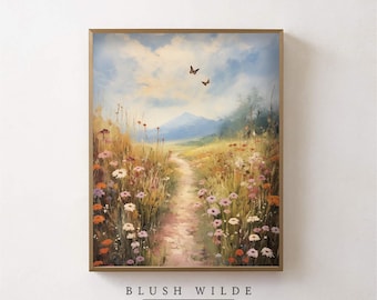 May include: Framed landscape art print featuring a path winding through a field of wildflowers, leading to a mountain range under a cloudy sky. Two butterflies flutter above the path. The text "BLUSH WILDE COLLECTIVE" is at the bottom.