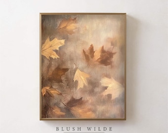 May include: A framed painting of a muted brown and beige abstract design with a soft focus. The painting features a collection of brown and beige leaves in a swirling pattern. The painting is framed in a gold frame and has the text "BLUSH WILDE COLLECTIVE" at the bottom.