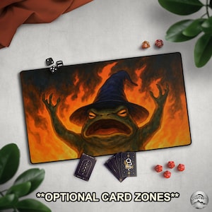 May include: A rectangular gaming mousepad featuring a green frog wearing a wizard hat, set against a fiery background. The mousepad includes the text "OPTIONAL CARD ZONES". Dice and playing cards are also present.