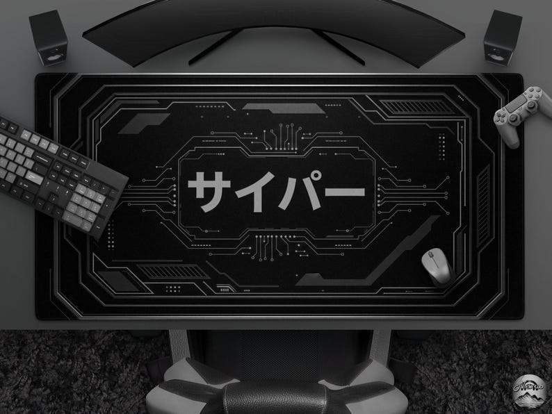 May include: Black desk mat with a circuit board design and Japanese text. The mat features a keyboard, mouse, and a game controller. A curved monitor and speakers are visible in the background.