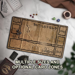 May include: A rectangular game playmat with a brown, textured cardboard appearance featuring black hand-drawn labels for Life Total, Commander, Tax, Battlefield, Library, Graveyard, Exile, and All Lands, accompanied by black dice and game cards.