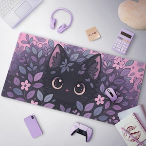 May include: A rectangular mousepad featuring a black cat face surrounded by purple and lavender leaves and flowers. The mousepad is on a white surface, along with a purple mouse, headphones, and other accessories.