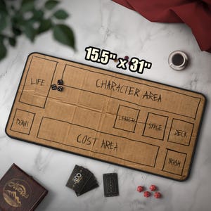May include: A rectangular game mat, measuring 15.5" x 31", with labeled areas for gameplay. The mat is brown with black outlines and text, including "LIFE," "CHARACTER AREA," and "COST AREA." Dice and cards are placed on the mat.
