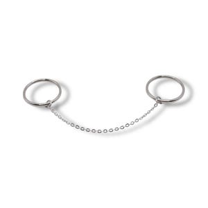 May include: A pair of silver rings linked by a fine chain. Each ring is a simple, circular band. The chain is composed of small, connected links. The jewellery is displayed on a white backdrop.