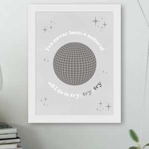 May include: A gray and white framed print with a disco ball and the text "I've never been a natural all I do is try, try, try".