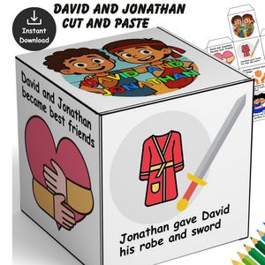 May include: A white cube with illustrations and text related to the story of David and Jonathan. The cube features images of two friends, a robe, and a sword. Text includes "David and Jonathan became best friends" and "Jonathan gave David his robe and sword."