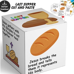 May include: A white cube with illustrations and text related to the Last Supper. The cube features images of bread, a chalice, and text that reads "Jesus breaks the bread and tells them it represents His body."