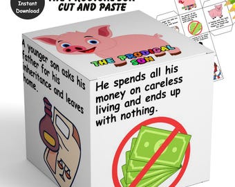 May include: A white, cut-and-paste cube with the text "THE PRODIGAL SON" and illustrations. A pink pig is on top. Text includes "A younger son asks his father for his inheritance and leaves home." and "He spends all his money on careless living and ends up with nothing."