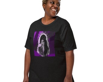 May include: A black t-shirt featuring a purple and white graphic of a woman with a halo. The woman is wearing a black jacket and has long dark hair.