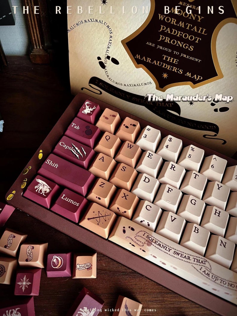May include: A custom mechanical keyboard with keycaps in burgundy, beige, and white. The keycaps feature various symbols and text, including "Lumos" and "The Marauder's Map." The keyboard is themed after the Marauder's Map from the Harry Potter series.